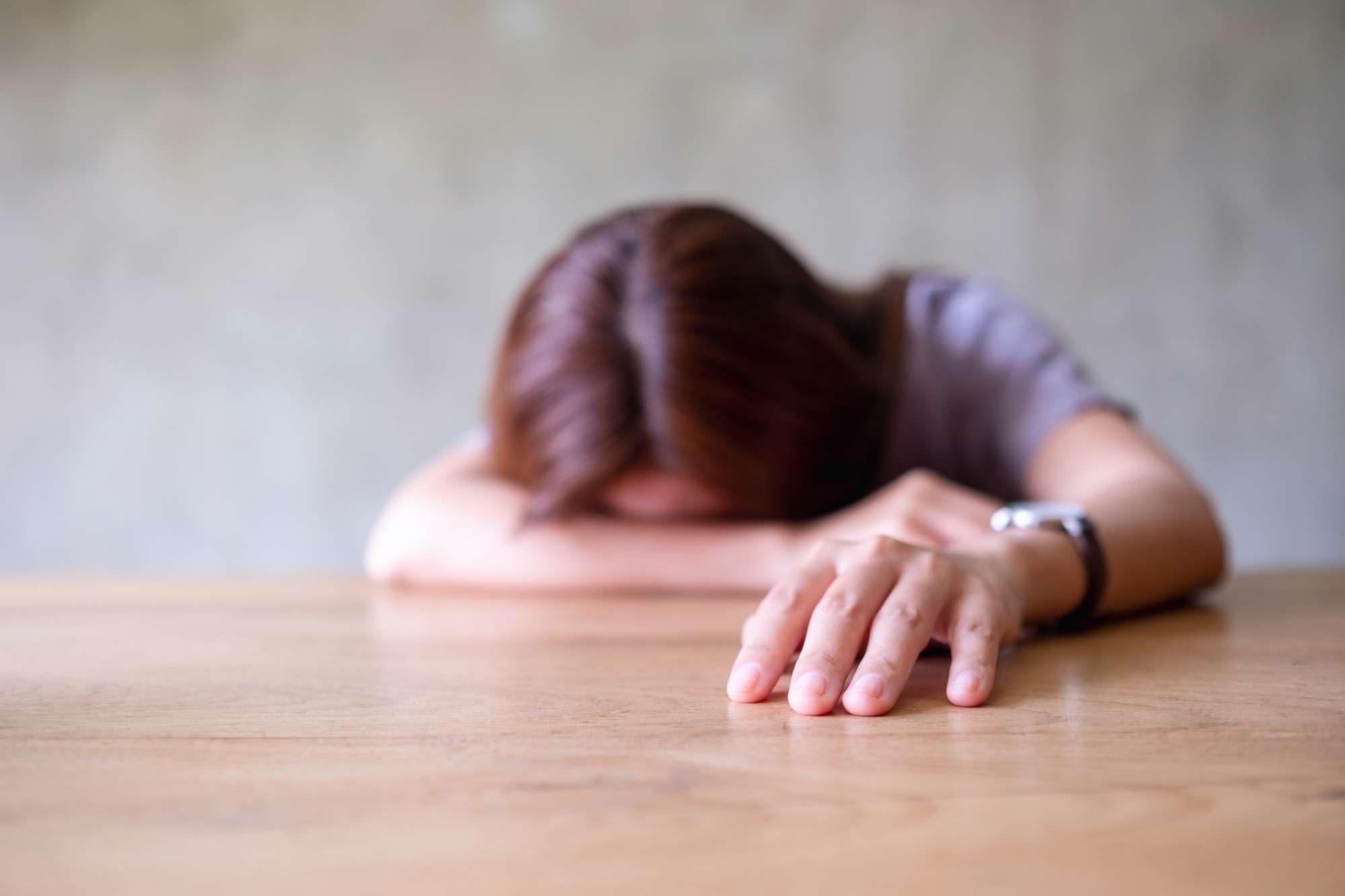 A young woman exhausted and burned out, symbolizing the struggle of staying faithful without burnout | Heaven Speaks