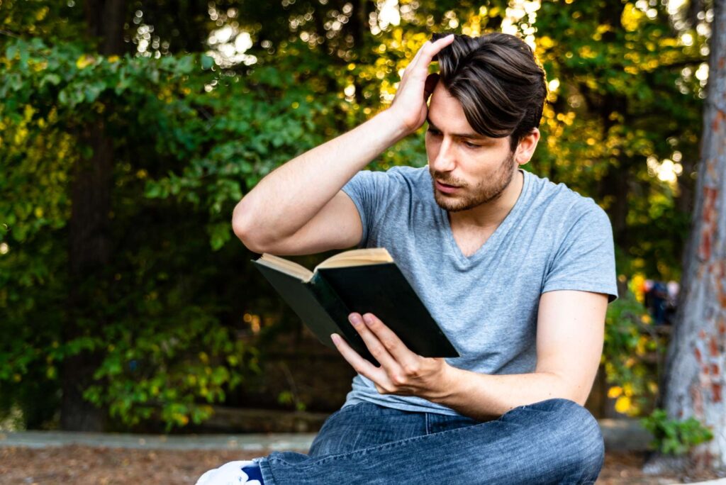 Man beginning his faith journey with God by reading the Bible outdoors | Heaven Speaks