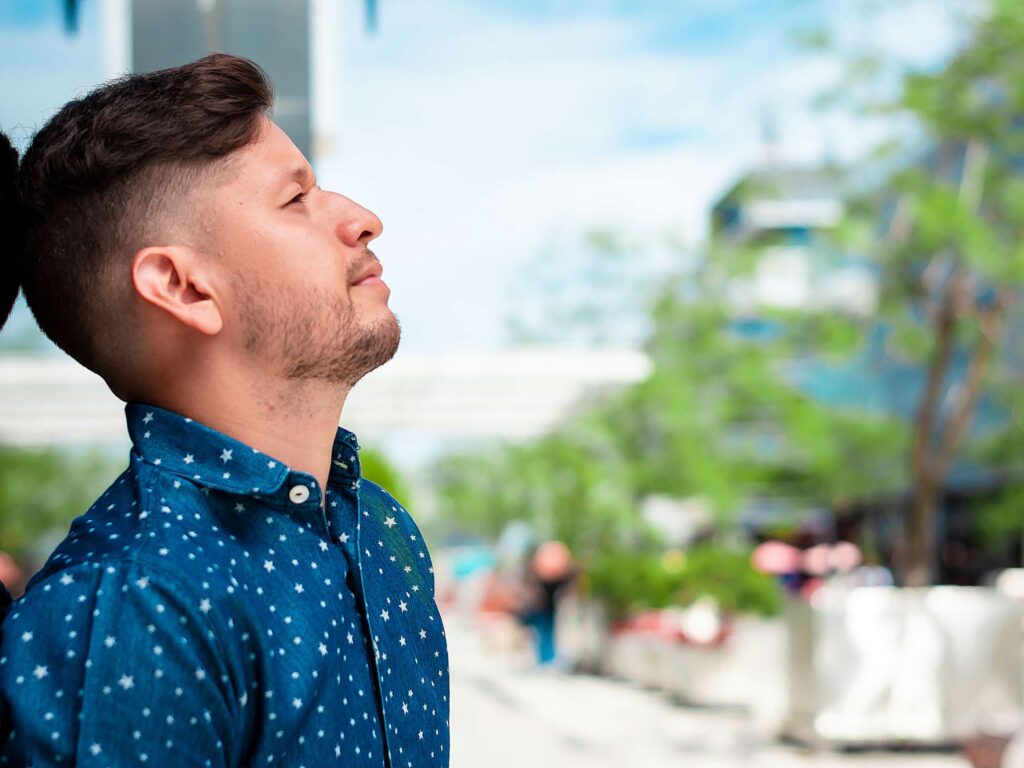 Man reflecting on faith, asking does God speak outside the church in ordinary life | Heaven Speaks