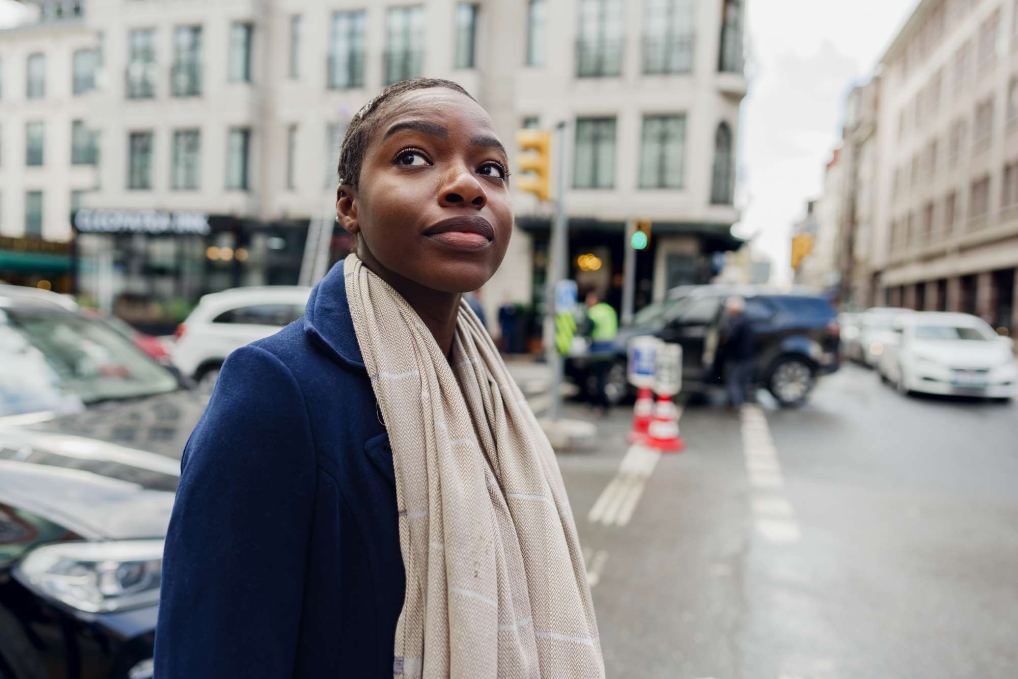 Christian woman pausing on a busy city street, reflecting on God’s presence outside church walls | Heaven Speaks