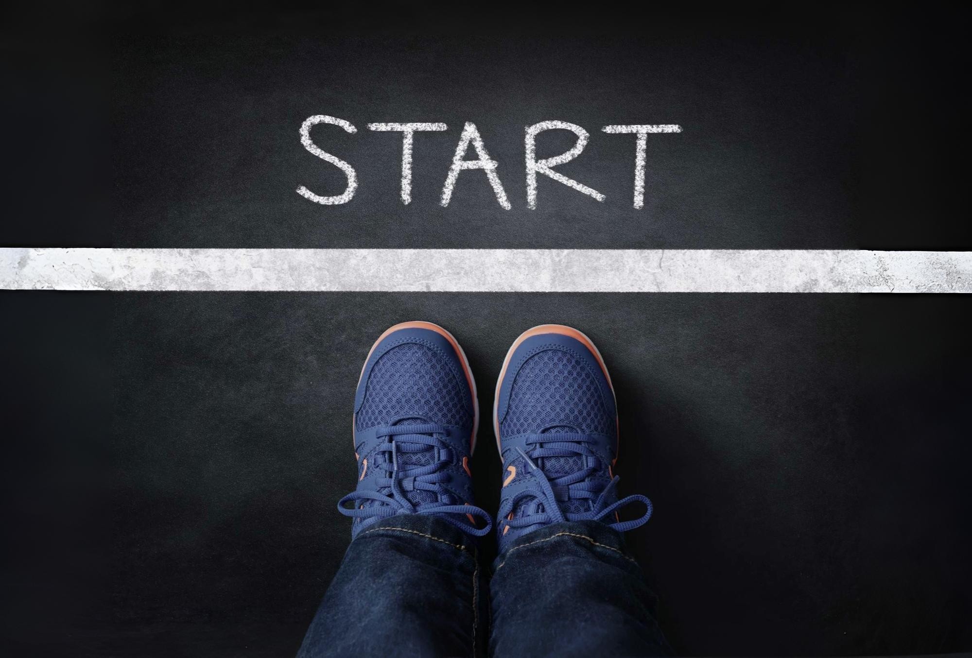 Feet standing at a starting line symbolizing faith to begin with courage without clarity and move when God leads.