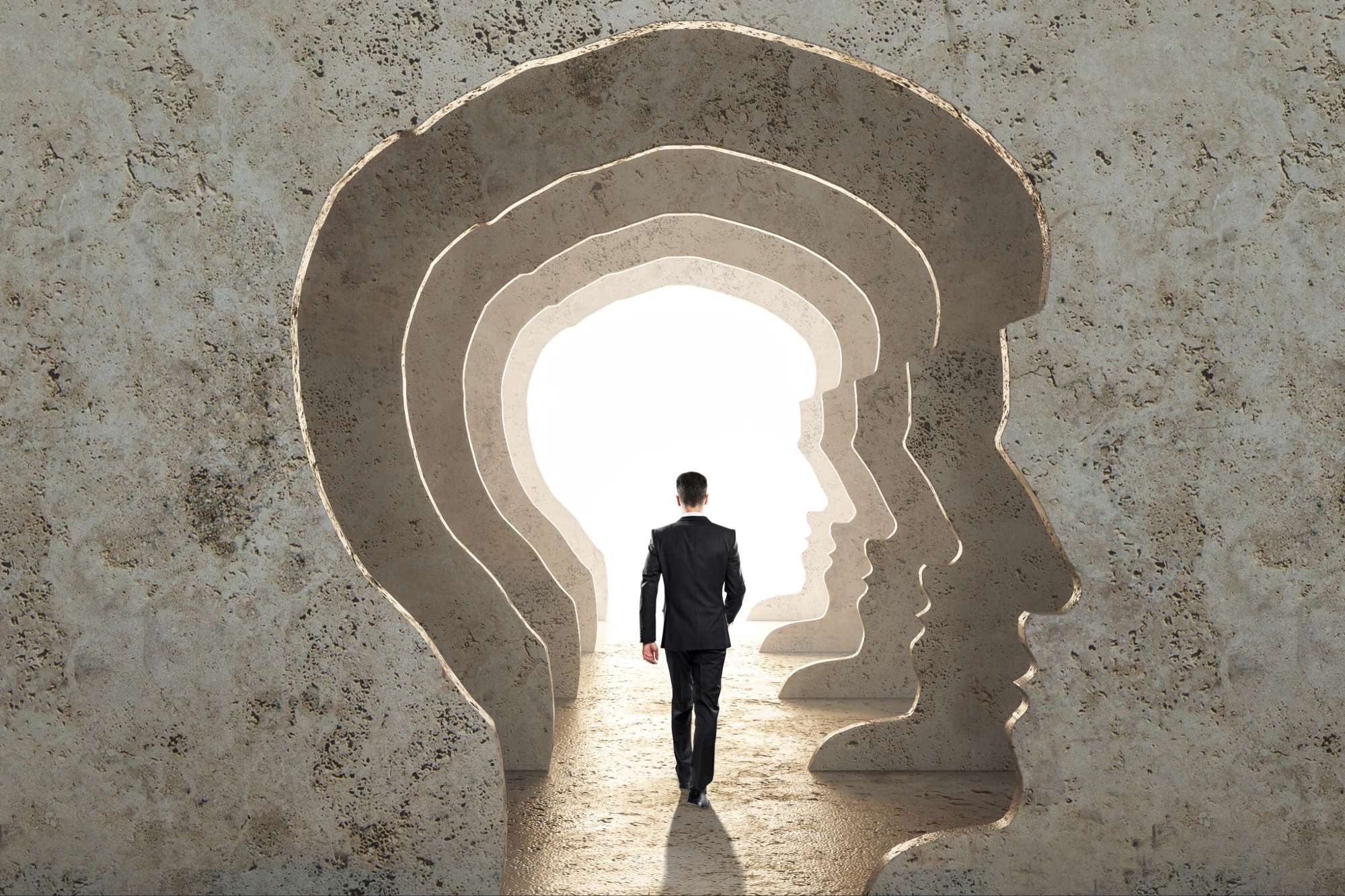 Man walking through layered human head silhouettes symbolizing holy deconstruction and deeper spiritual understanding