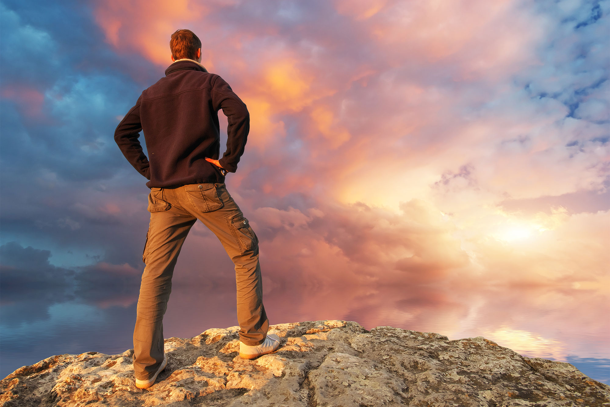 man standing on cliff looking toward the horizon symbolizing trusting God when you don’t understand